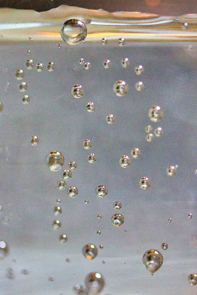 Water bubbles in a glass: sparkling water close up