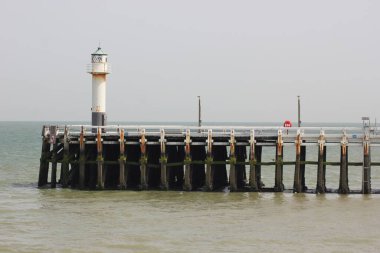 Seaside in the North of Belgium: pier and lighthouse