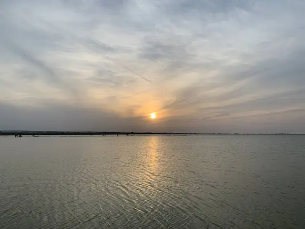 stock image Beautiful delicate sunset over the lagoon: golden hour reflection