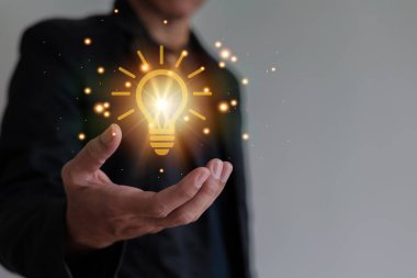 Hand of man show illuminated light bulb. Idea about innovation and inspiration. Concept creativity with bulbs that shine glitter. Inspiration of ideas for sustainable business development