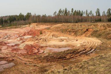 The rugged beauty of Lode Quarry in Latvia invites exploration, where each step unearths a story written in the earth's ancient clay. clipart