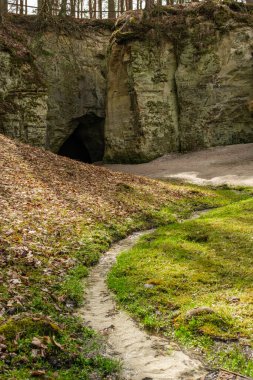 Small Hell Cliffs near Cesis offer a glimpse into the past, where layers of history are etched into the very stone of Latvia's countryside. clipart