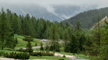 Experience the breathtaking journey along this serpentine road as it weaves through the stunning peaks of the Dolomites, offering awe-inspiring views at every turn clipart