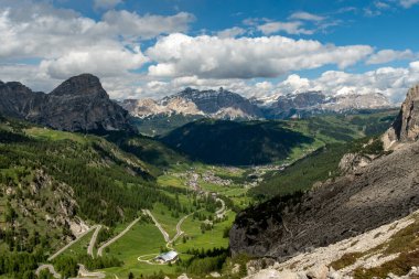 Enjoy the striking mountain views of Gardena Pass from the Sella Group trail, where the towering peaks and tranquil alpine beauty create an unforgettable scenic experience clipart