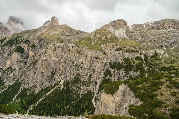 Haziran 'da Dolomitlerin eşsiz güzelliğini yakalayan yemyeşil çimenlerin ön planına karşı kar kaplı Kir Grupları' nın çarpıcı kontrastını deneyimleyin.