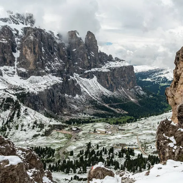 stock image Experience the striking contrast of the Cir Groups snow-capped peaks against a foreground of lush green grass capturing the unique beauty of the Dolomites in June