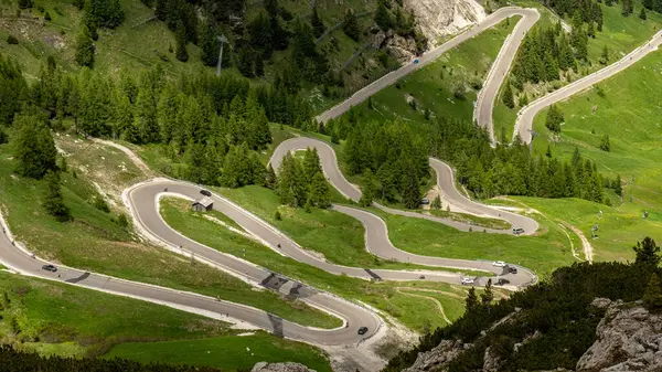 stock image Navigate the picturesque serpentine road in Gardena Pass, revealing breathtaking vistas of the Dolomites' rugged beauty and alpine splendor