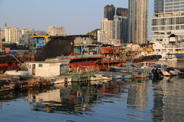 A city with a lot of boats and a lot of buildings. The water is calm and the sky is blue clipart