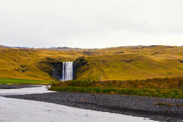 Cloudy sky over the mystical landscape of Iceland, Skogafoss