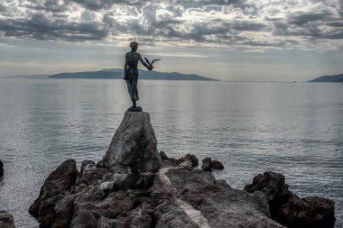 The historic statue of Maiden with the seagull is a symbol, not only of Opatija, but the entire Kvarner region. The statue on Adriatic coast is in the touristic town of Opatija in Croatia, Europe clipart