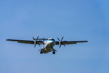 Mavi gökyüzünde uçan uçak.