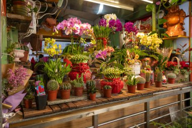 A flower shop located in Dongsanshui Street Market, offering a vibrant array of blooms and greenery. clipart