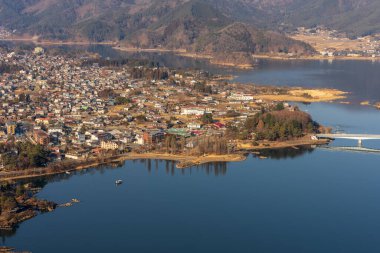 Fujiyoshida, Japan, January 22, 2025: Fujiyoshida and Lake Kawaguchi seen from above clipart