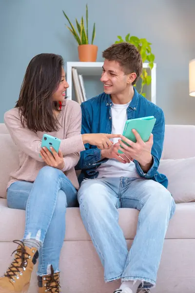 Young Smiling Multiracial Couple Sits Couch Home Using Gigital Tablet — Stock Photo, Image