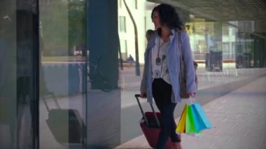 Reklam, İş, Seyahat, Alışveriş Konsepti - havaalanında çanta, alışveriş çantası, pasaport ve biniş kartı taşırken yürümek.