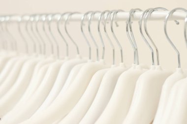 Beyaz bir arka planda izole edilmiş bir sürü beyaz askı var. Kara Cuma. Dükkan konsepti, satış, tasarım, boş askı. Askı manto. Yüksek kalite fotoğraf