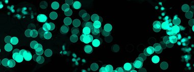 Aqua ve parlak bokeh ışıkları koyu arkaplan üzerine dairesel desenler halinde dağılmış. Bilim, teknoloji veya soyut tasarım için ideal.
