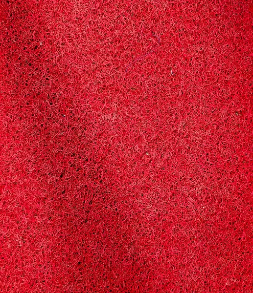 Yumuşak yüzeyi olan kırmızı keçeli kumaş dokusu ve tüylü sıcak tekstil hissi.
