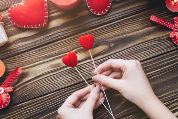 Valentines day concept. Hand make yarn red heart beside wooden block calendar set on Valentines date 14 February on table and bright room background. Happy valentine day.