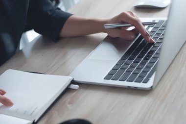 İşletme ve Finans. Ofiste dijital tablet ve dizüstü bilgisayar kullanan bir iş adamı. İşadamı çalışıyor, tablet ekranda dokunuyor ve dizüstü bilgisayarda yazıyor, iş verilerini araştırıyor, sörf yapıyor. 