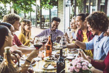 Bir grup arkadaş bahçe restoranında yemek yiyor.