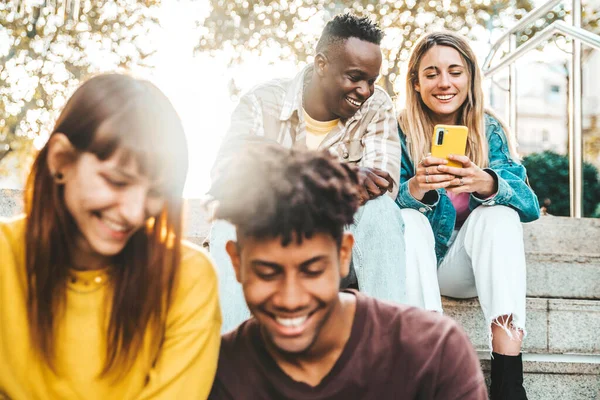 Multicultural Millennial People Using Smart Mobile Phone Device Sitting Outdoors — Stock Photo, Image