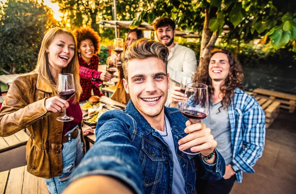 パティオのテラスハウスで赤ワインを食べたり飲んだりして外で凍る若者 食と若者の友情の概念 — ストック写真