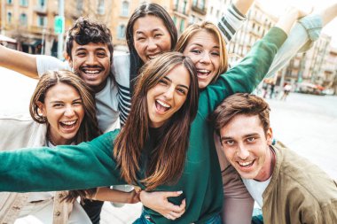 Millenial friends having fun hanging on city street. Friendship concept with guys and girls enjoying day out together. Youth community concept clipart