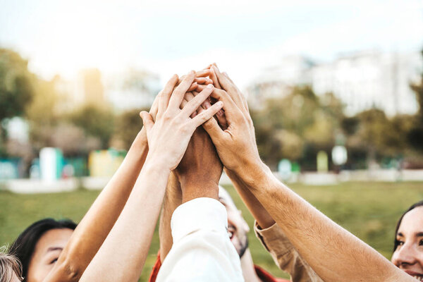 Multiracial college students putting their hands on top of each other - Human relationship, social, community and team building concept
