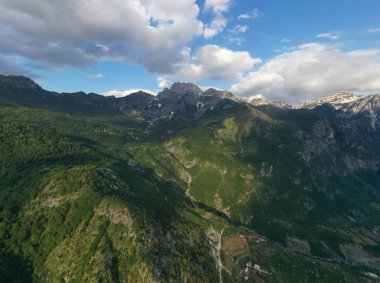 This breathtaking image showcases the serene sunset over Albania's Shkoder rugged mountains, highlighting the dramatic contours and the play of light that creates a peaceful yet awe-inspiring mood.