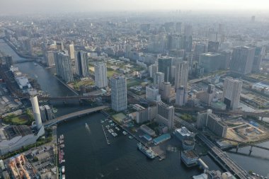 Tokyo's skyscrapers stand tall beside winding rivers in this aerial photograph taken at dusk, with the city's lifeblood flowing through.