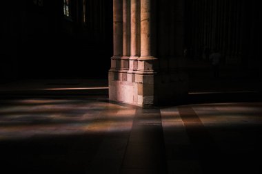 Be captivated by the dance of sunlight through stained glass, creating a kaleidoscope of colors on the floor of a Gothic cathedral in Cologne, Germany.