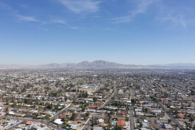 The suburban expanse of Las Vegas stretches towards the horizon, offering a serene yet striking contrast to the city's neon core, all captured from the soaring height of a drone.