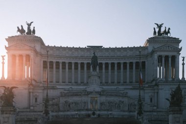 The Altare della Patria stands bathed in the soft light of dawn, its statues and columns a proud emblem of Rome's rich heritage.