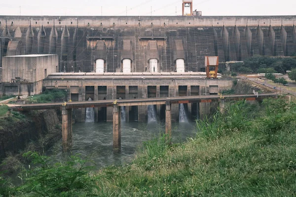 The Itaipu Dam, embedded in the Brazilian landscape, showcases the industrial beauty and magnitude of one of the world\'s largest hydroelectric facilities. The cascading water and the imposing concrete structure create a harmonious blend of nature\'s p