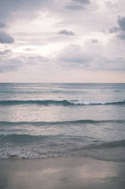 As twilight sets over Patong Beach, the serene waters reflect the calm skies, providing a moment of tranquility and a beautiful end to the day in Phuket, inviting contemplation and peace.