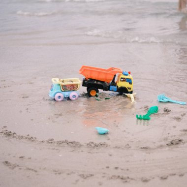 Colorful children's beach toys left behind on the sands of Patong Beach, evoking memories of playful days and carefree joy.