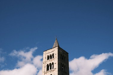 The serene bell tower pierces the vast blue sky, a silent and enduring symbol of Spain's rich history and architectural beauty, nestled in the heart of a quaint town.