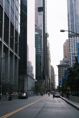 This image captures the bustling atmosphere and architectural grandeur of New York City's urban landscape, with towering skyscrapers lining the streets and the vibrant life of the city on full display. Perfect for editorial use, this photo conveys th