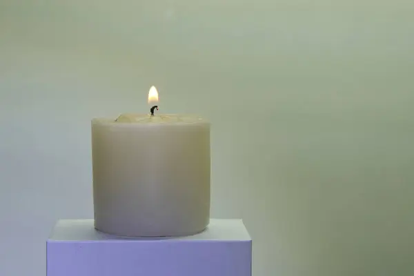 Candles burning against a white background illuminate a hope of faith