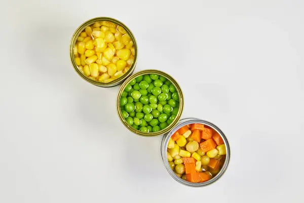Çok renkli konserve sebzeler, zenital veya üst çekim beyaz arkaplan ve metin için boşluk
