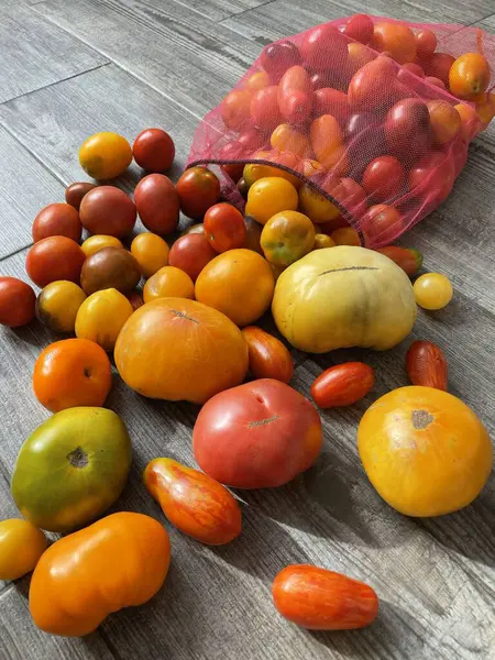 Colorful farmer\'s tomatoes. Experience the vibrant flavors of farm-fresh tomatoes in a rainbow of colors. From deep reds to bright yellows, these colorful farmer\'s tomatoes are sure to add a burst of freshness to any dish.