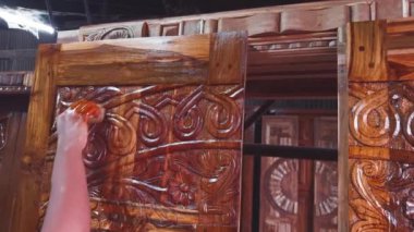 Asya ve Hindistan 'daki bir atölyede ahşap bir panele el yapımı ahşap oje oyma.