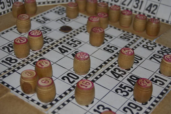 Lotto. Board game. Cards with numbers are covered with barrels. The game originates in the 16th century in the city of Genoa, which is located in Italy.