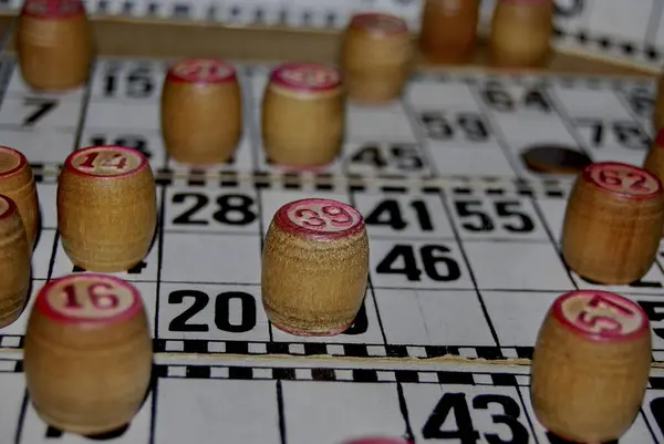 Lotto. Board game. Cards with numbers are covered with barrels. The game originates in the 16th century in the city of Genoa, which is located in Italy.
