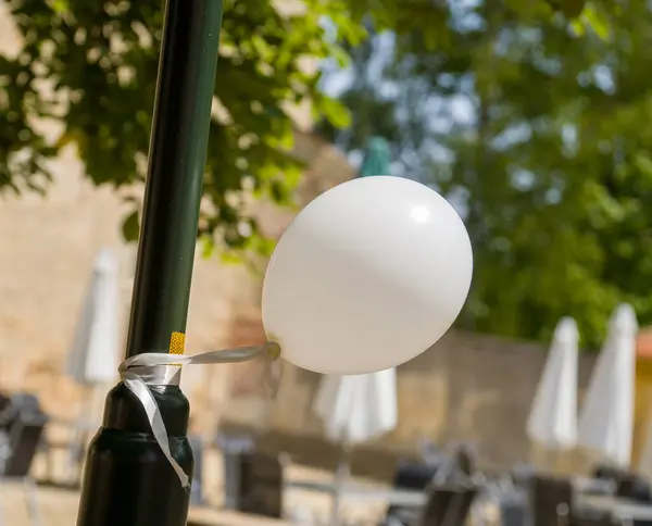 white balloon on a street