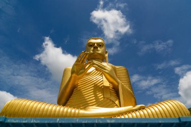 Golden Buddha statue at Dambulla cave teple complex clipart