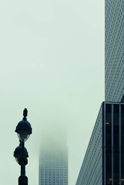 Empire State building in fog, Manhattan