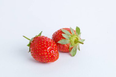 Beyaz arka planda iki çilek kapanıyor.