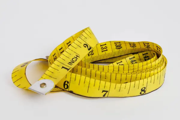 stock image Yellow measuring tape with a white background.